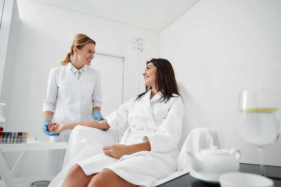 healthcare professional at PBK Medspa in Brooklyn, NY, administering IV therapy to a relaxed patient